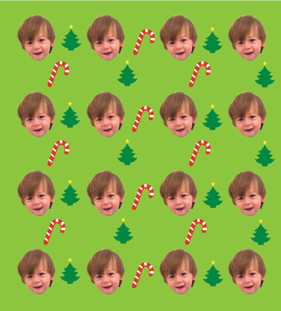 A giftwrapping paper pattern consisting of candy canes, Christmas trees and a little boy's face