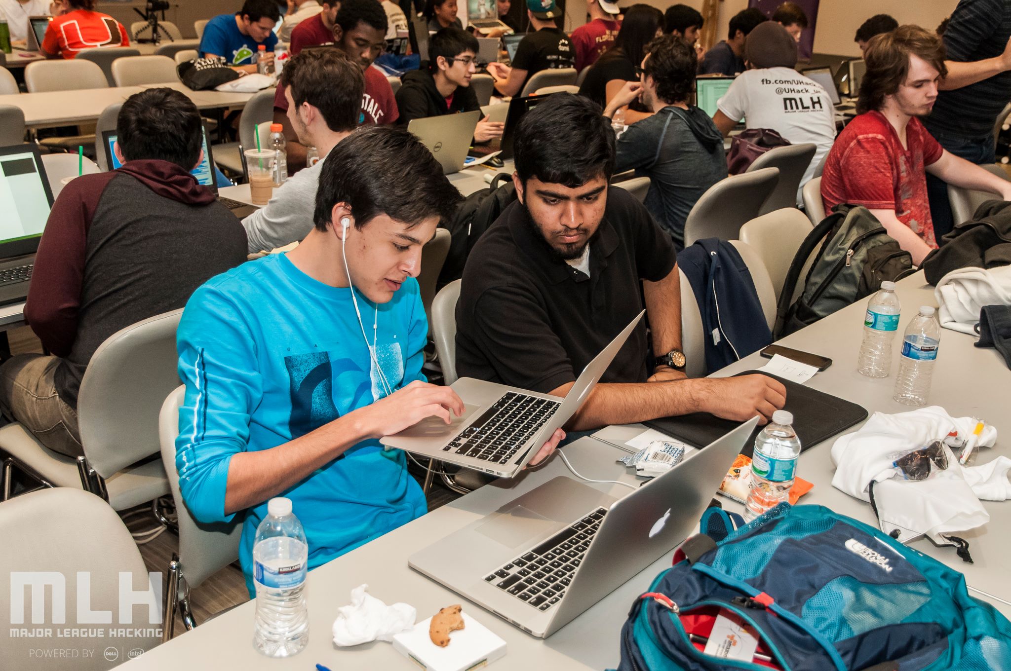 Two male students working at a hackathon