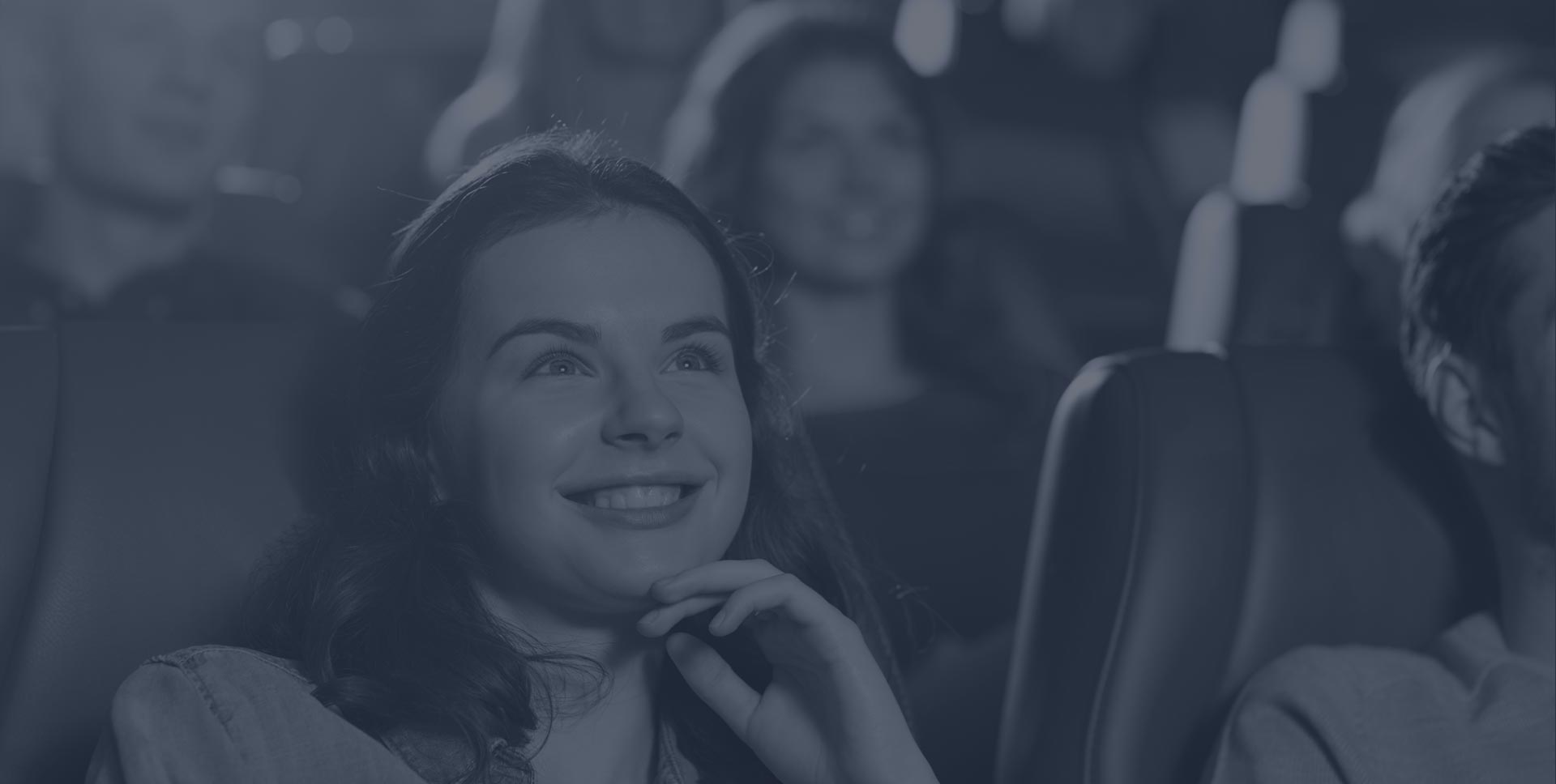 Photo of a cinema audience, symbolizing face and emotion recognition software