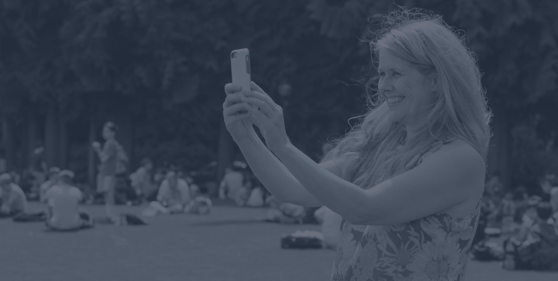 Photo of woman taking a picture of high-school students